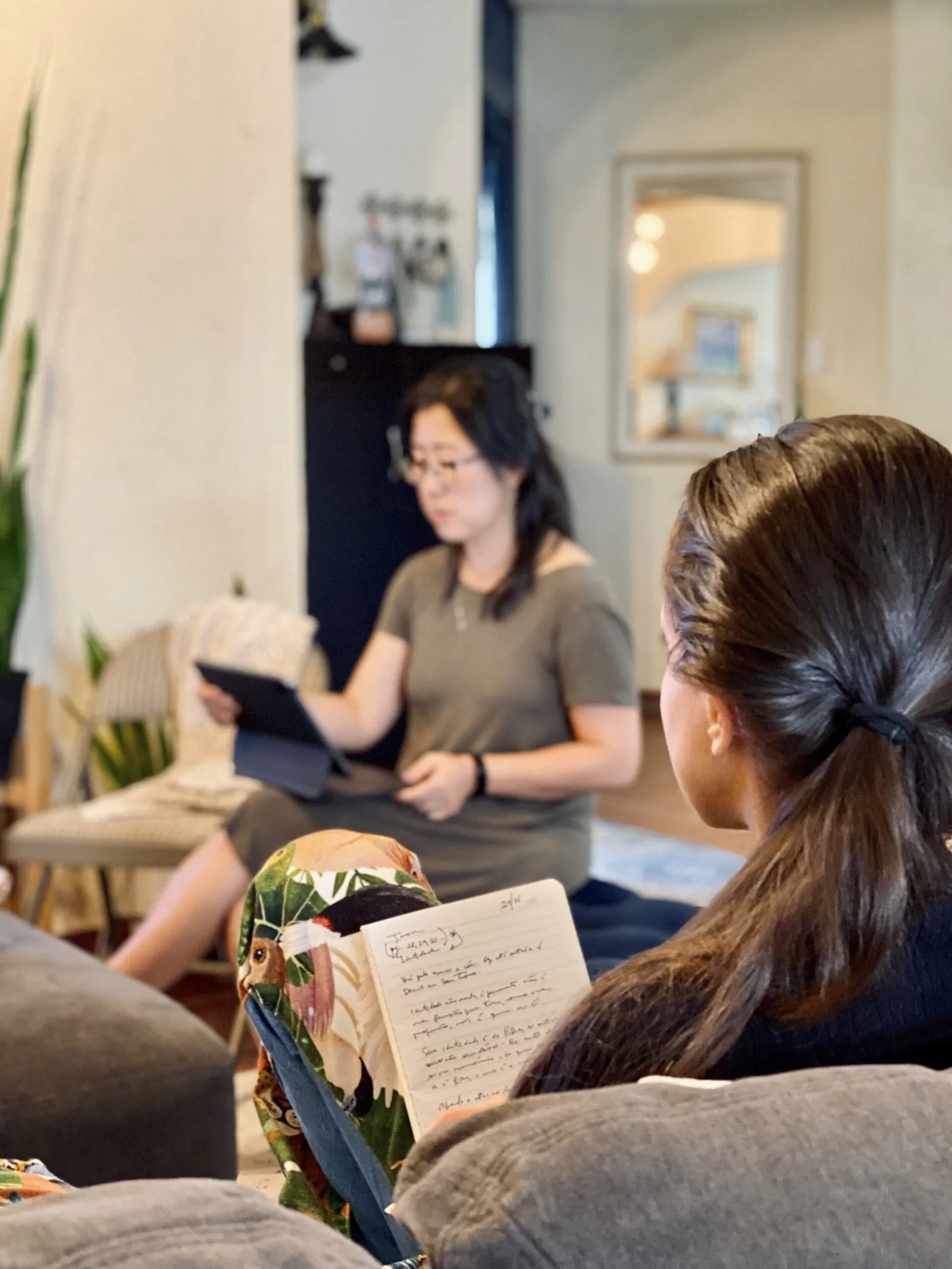 A student taking notes while an instructor teaches